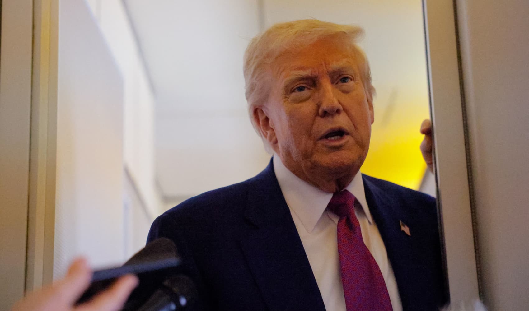 U.S. President Donald Trump talks to reporters aboard Air Force One, en route to Abu Dhabi, United Arab Emirates, on May 15, 2025.